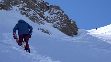 Skier-Hiking-up-a-Snowy-Mountain