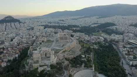 aerial orbit around acropolis hill in athens at first light