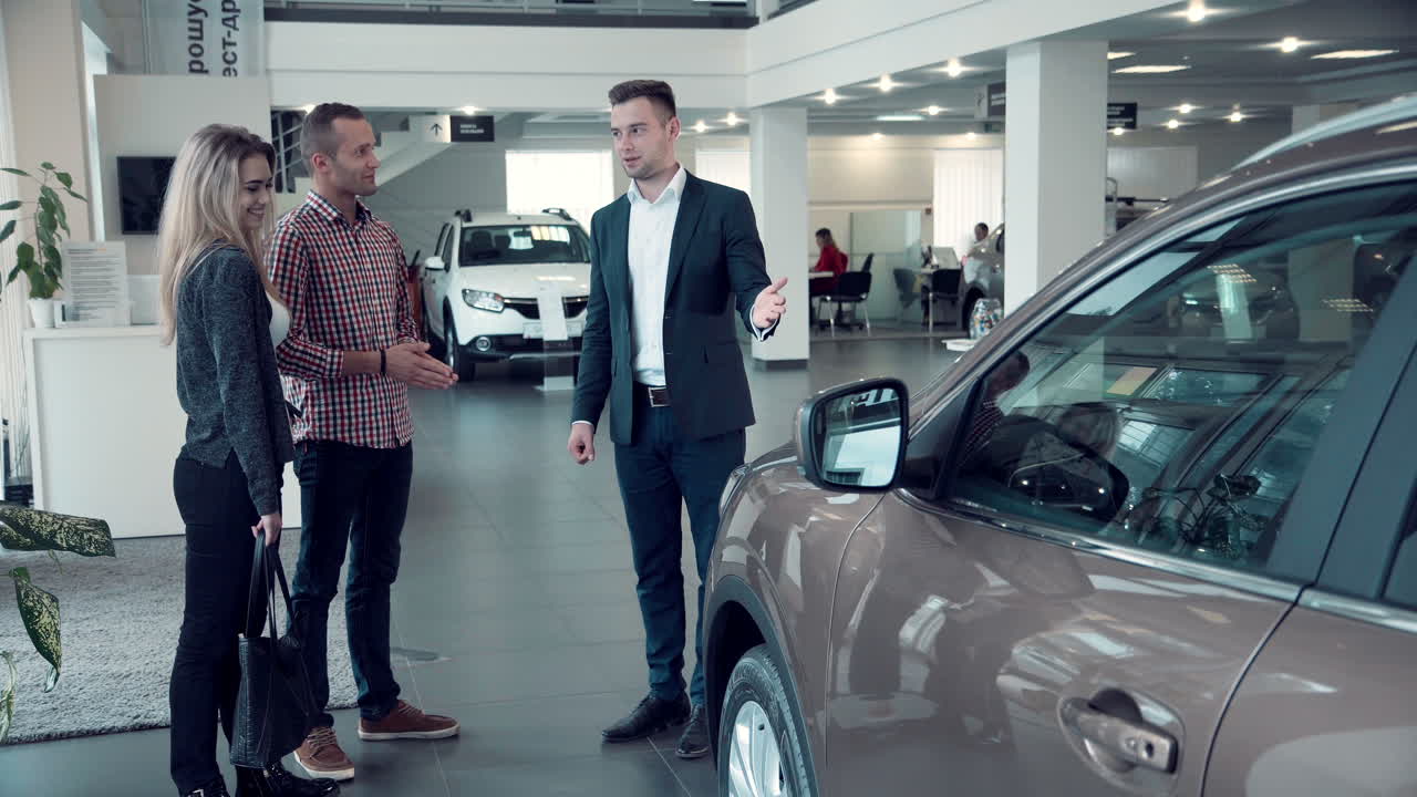 Couple looking at a car in a car showroom