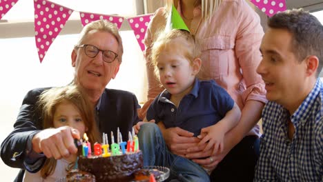 grandfather lighting candles on birthday cake 4k