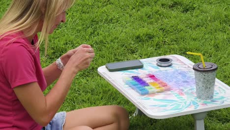 woman beading outdoors