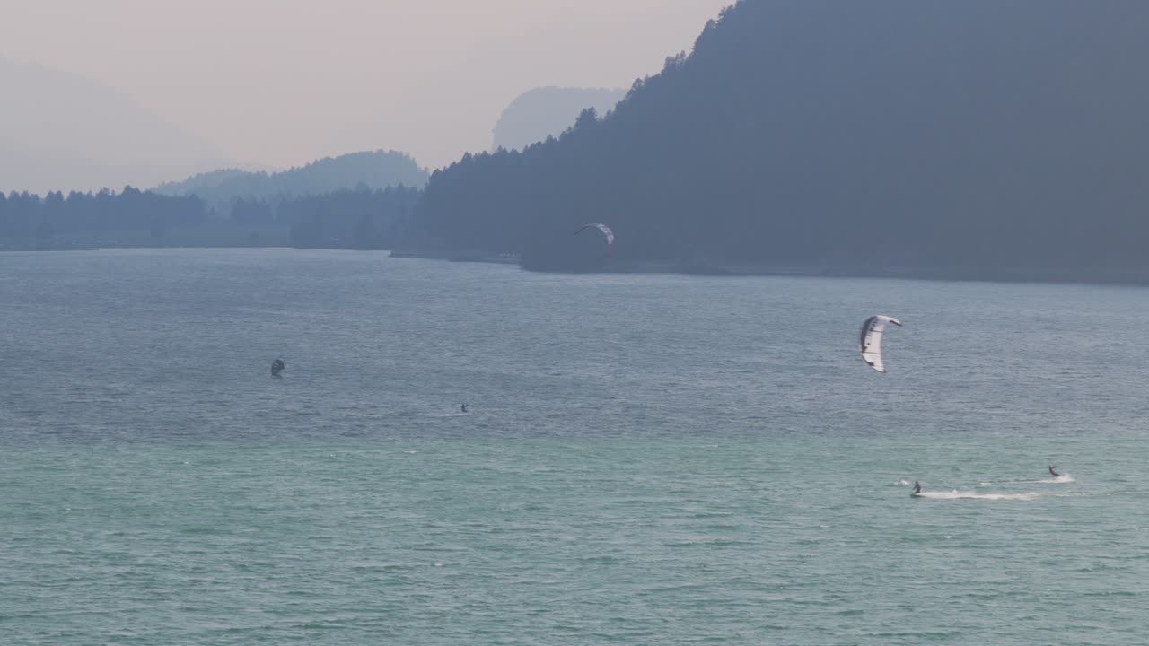 Aerial drone view of kitesurfers on beautiful Lake Silvaplana, surrounded by Swiss Alps, Switzerland