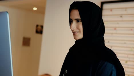 middle east woman at work wearing headscarf hijab and abaya