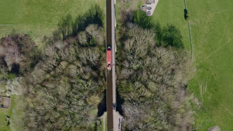 a narrow boat crossing the pontcysyllte aqueduct famously designed by thomas telford, located in the beautiful welsh countryside, famous canal route