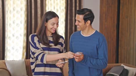 Happy-Indian-couple-counting-money