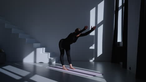 woman doing yoga in a studio