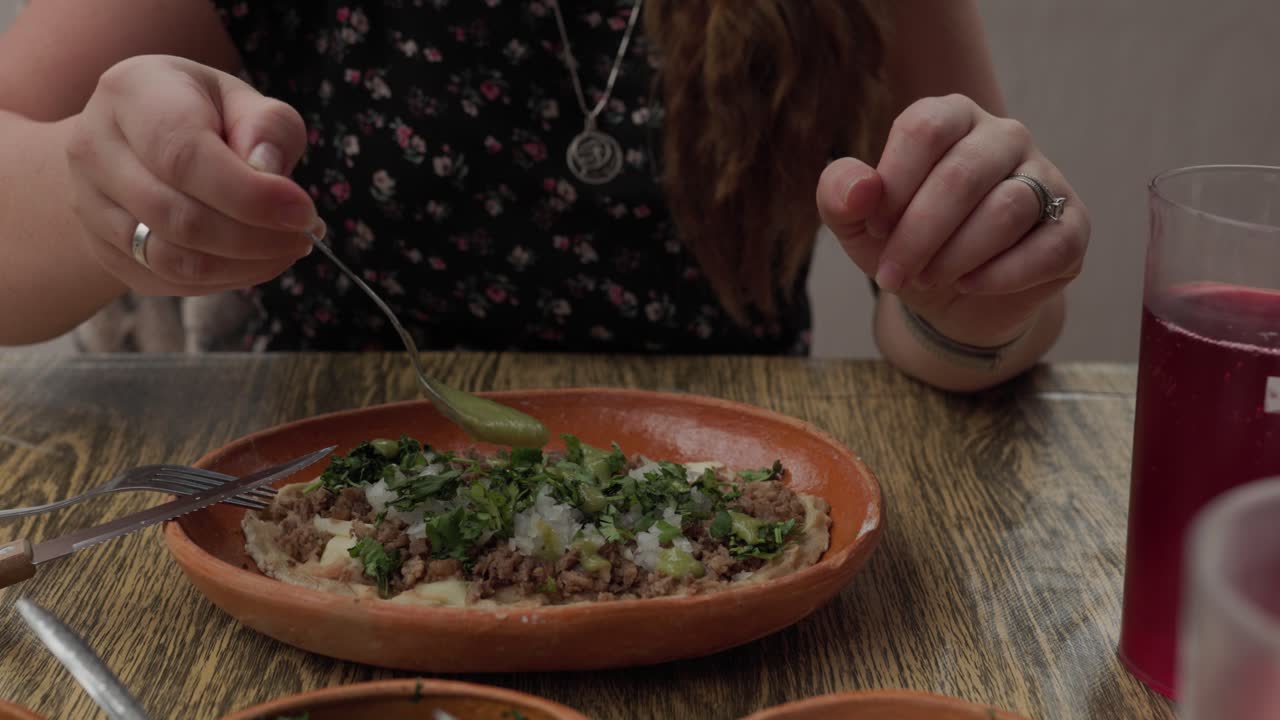 Person Eating A Traditional Mexican Dish Of Chilaquiles. Close-up Shot