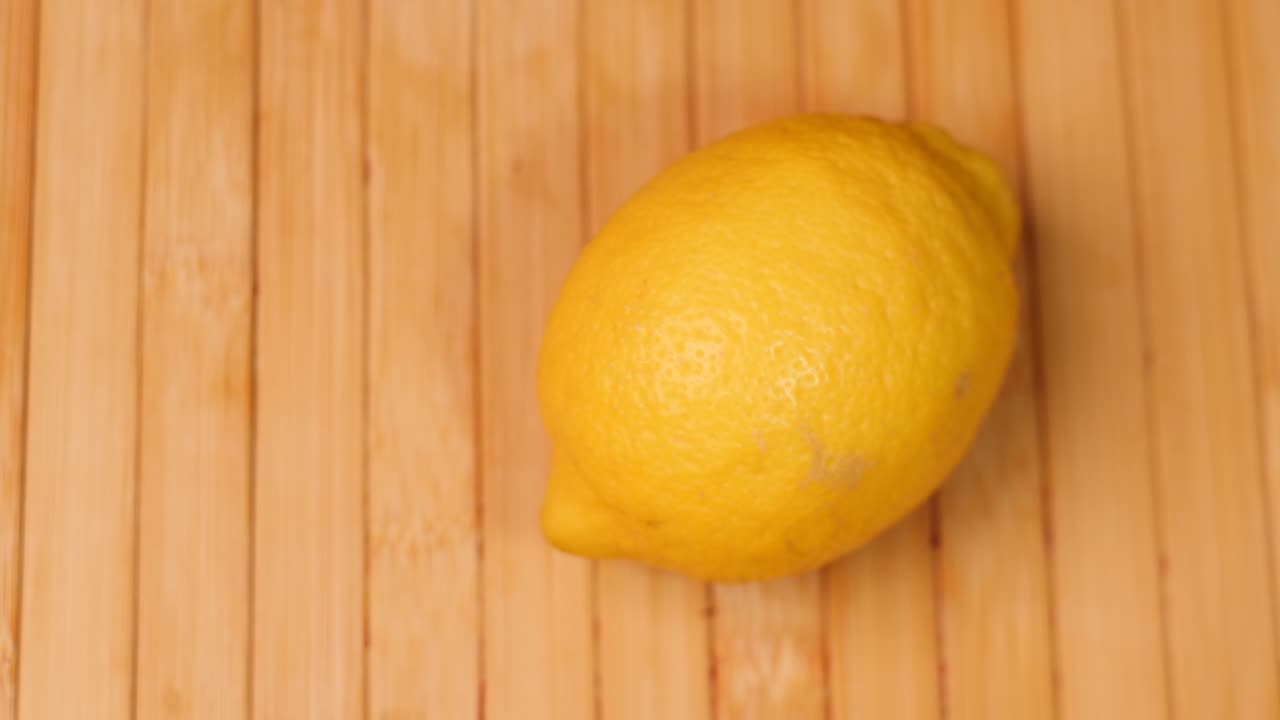 Spinning a ripe lemon citrus fruit for cocktail