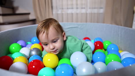 baby boy playing in a ball pit