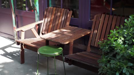 empty cafe patio with wooden chairs and a table