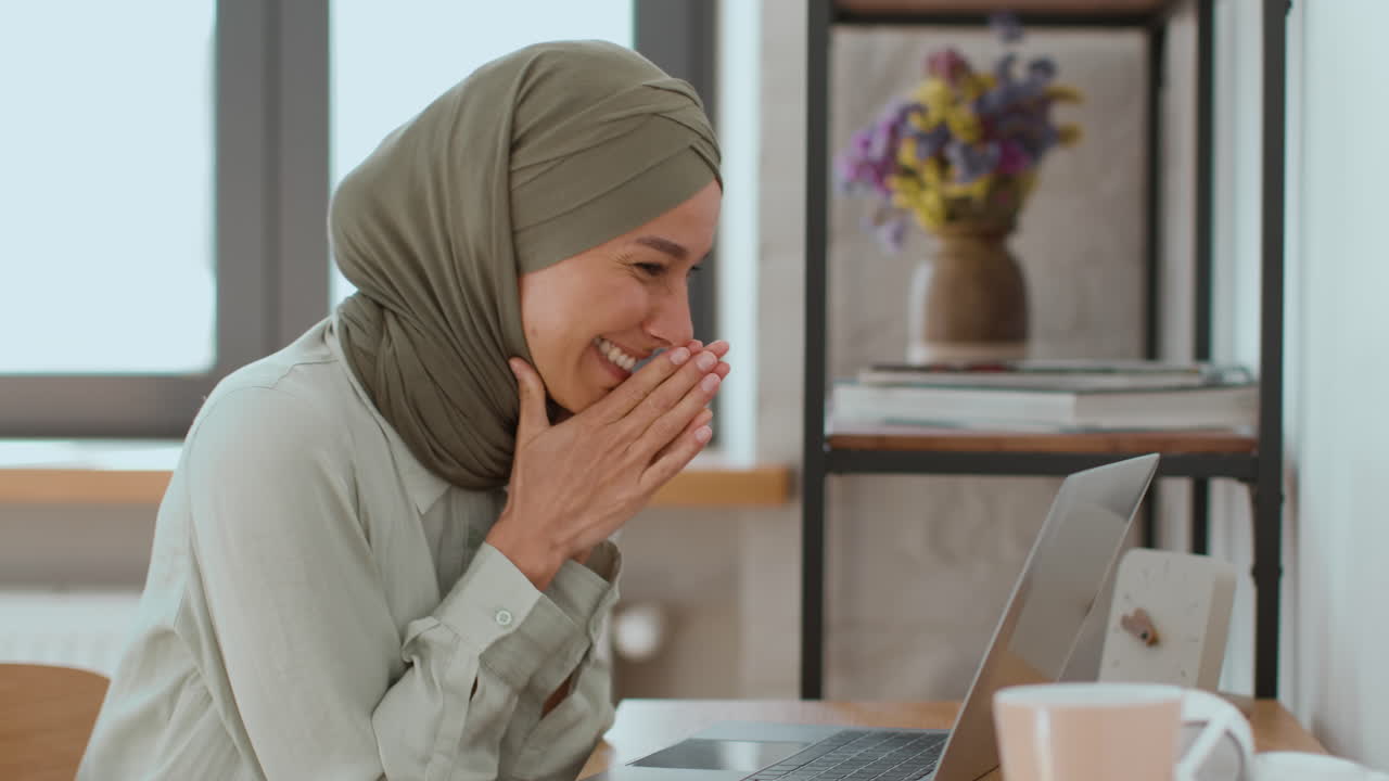 Happy Woman Celebrating Success on Laptop