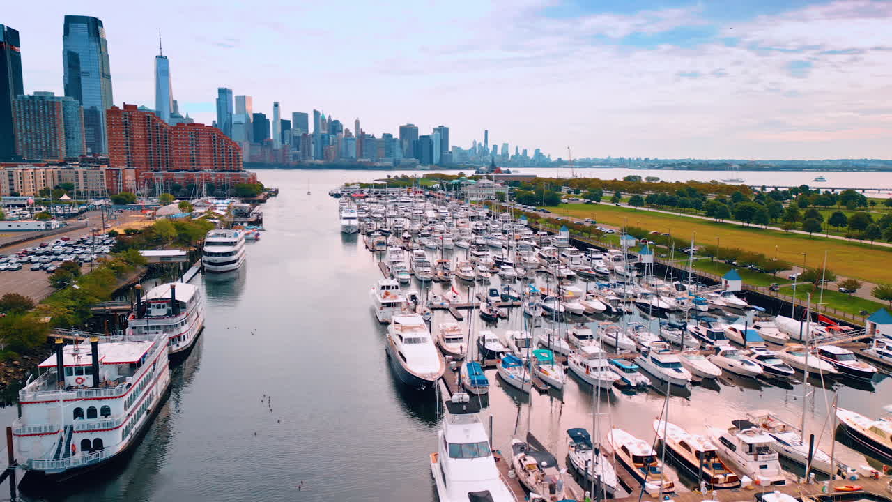 Lots of boats and yachts in the bay of Jersey City, USA. Manhattan skyline at backdrop