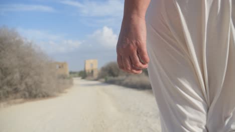 approaching an ancient greek ruin, slow motion following a woman in a white robe