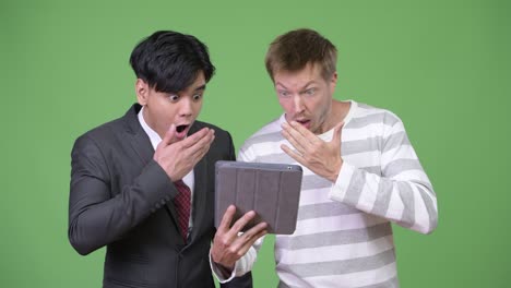 young handsome asian businessman and young scandinavian businessman working together