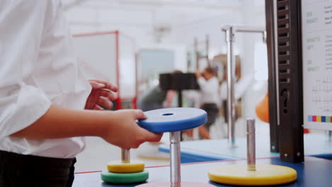 young white boy doing practical experiment at science centre