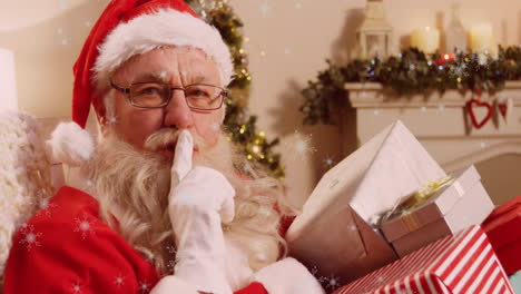 snowflakes falling against santa claus holding gift with finger on lips