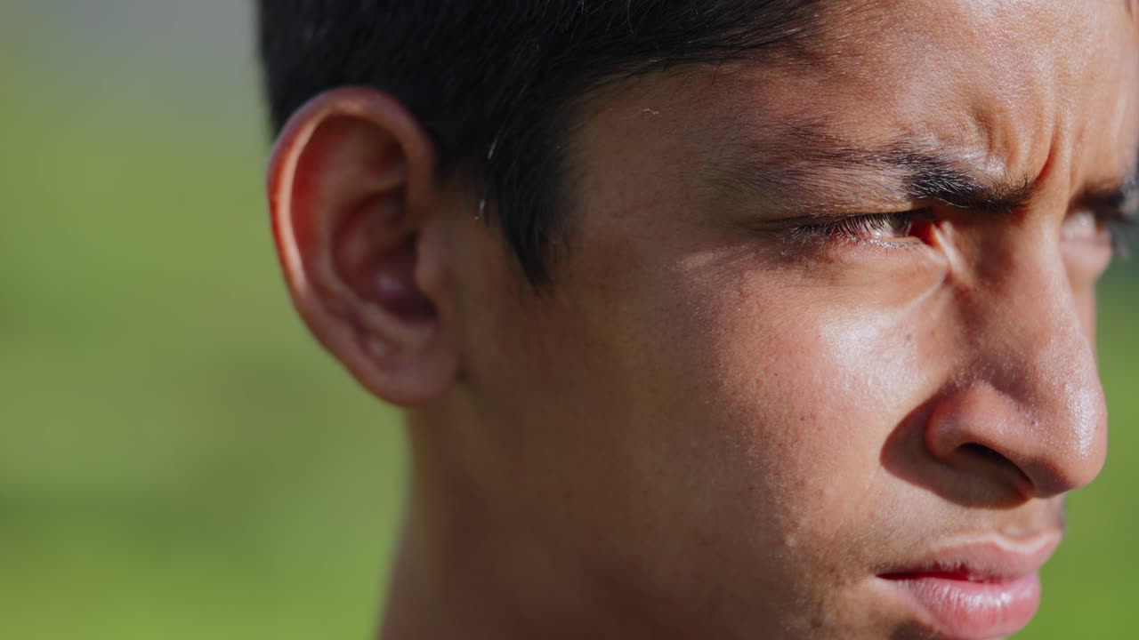 Close-up of anxious Indian child standing in wet rice field, looking around with uncertainty, 4k video