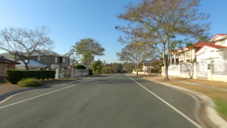 rear facing driving point of view pov of quiet australian suburban city street - ideal for interior car scene green screen replacement