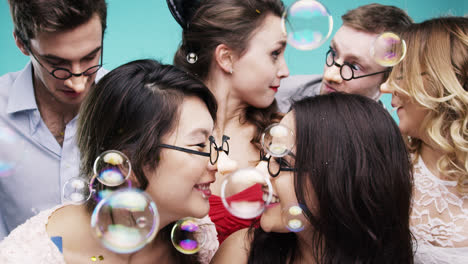 Multi-racial-group-of-people-wearing-false-noses-slow-motion-party-photo-booth