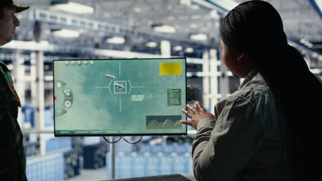 military data center coworkers looking at radar software on screen