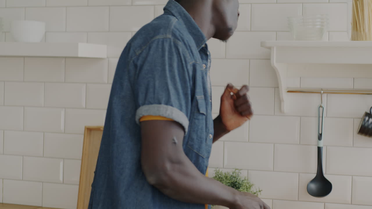 Man Cooking and Dancing in Kitchen