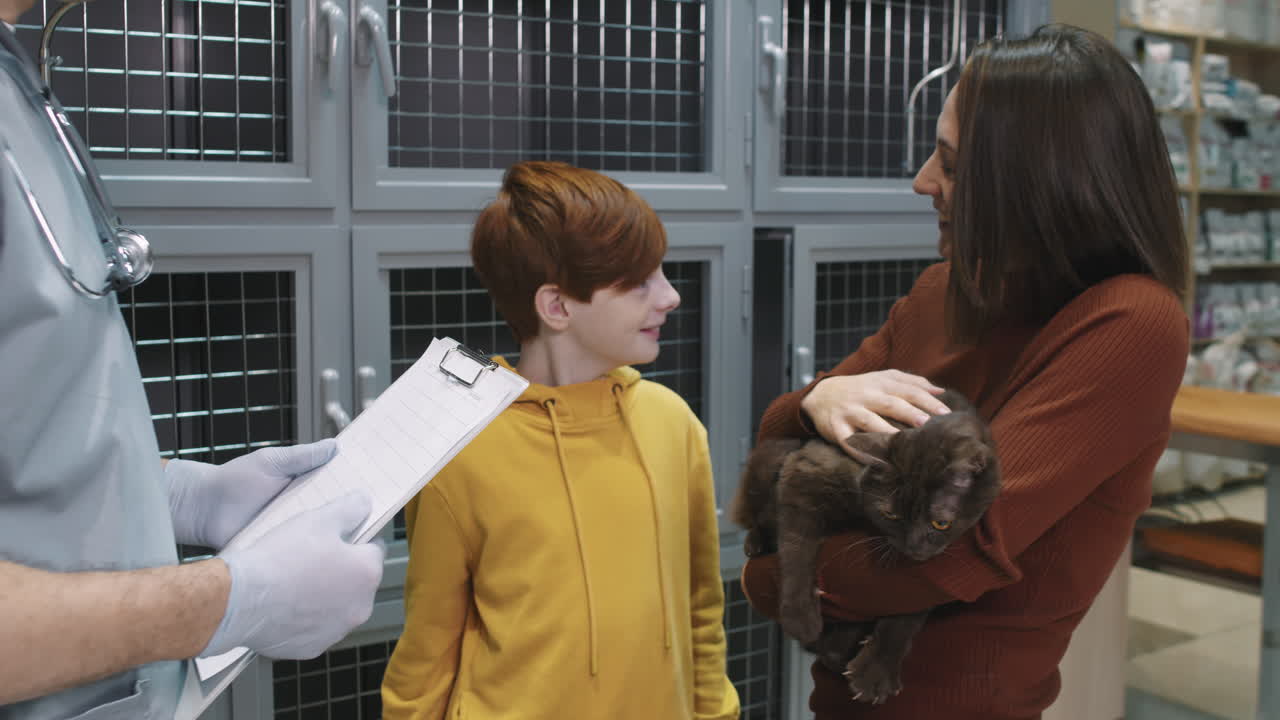 Pet Owners Picking Cat Up From Vet Clinic