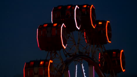 close-up of ferris wheel by rotating at night.