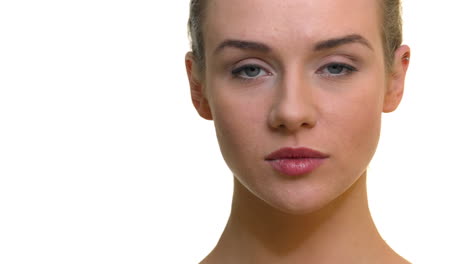 a close-up of a woman's face with a neutral expression