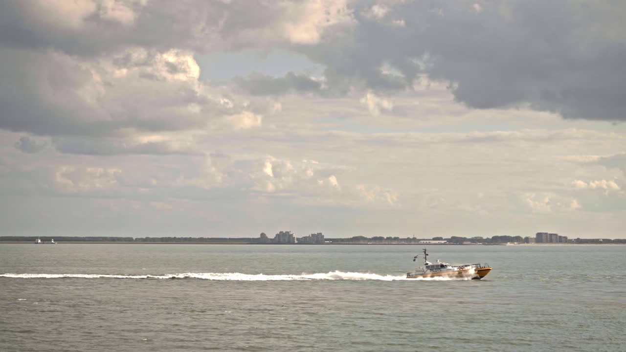 Pilot boat crossing the scene on a cloudy summer day in Vlissingen Netherlands