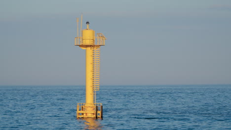 yellow buoy in the ocean during daytime