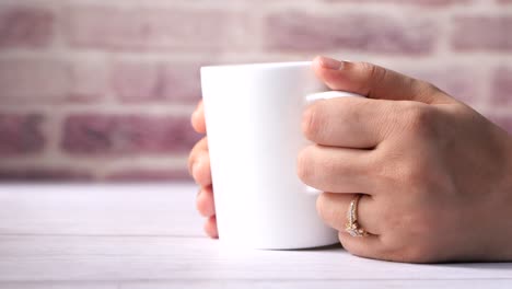 woman holding a white mug