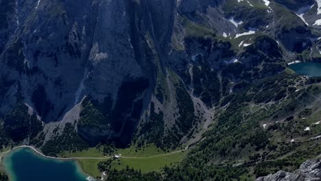 aerial camera pan (right to left) of mieminger mountains in austria tyrol with drachensee, lodge coburger hütte and seebensee. sunny summer day with blue skys. vantage point is peak of sonnenspitze