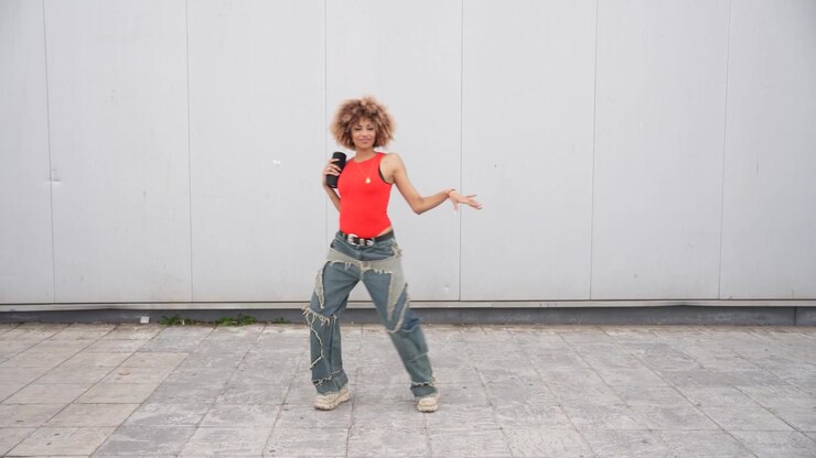 Dynamic dance movement set against an urban backdrop showcasing energy and artistry