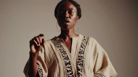 elegant african woman in traditional attire with expressive hand gestures