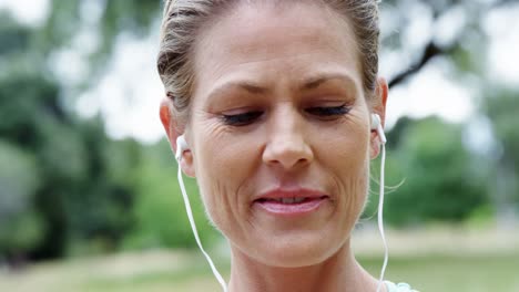 female athlete listening to music on mobile phone