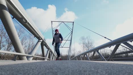 Elder-person-enjoying-ride-on-longboard-during-sunny-day