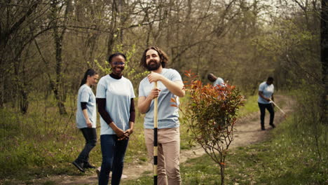 portrait of diverse activists team tidying natural environment