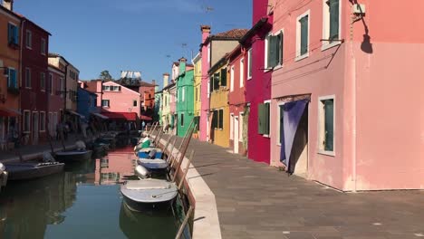 lovely slow motion video of colourful boats on the water during a sunny and beautiful day in italy