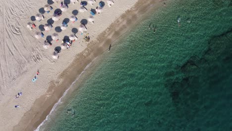 greek summer | top view aerial spinning shot of golden shores in the aegean sea, greece | 4k