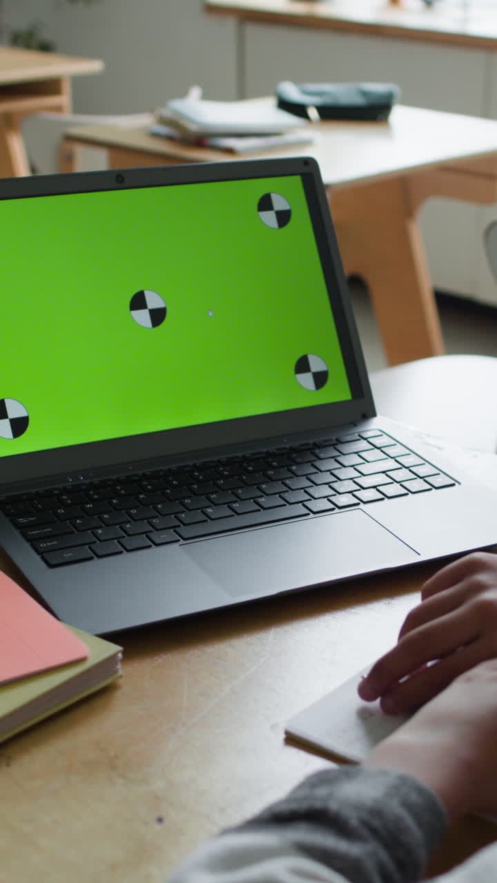 Student working on laptop in classroom