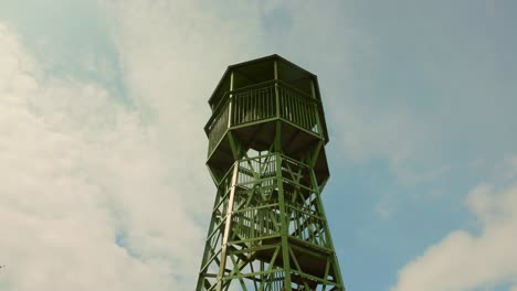 Lookout-tower-in-Cheddar,-England-against-a-partly-cloudy-sky