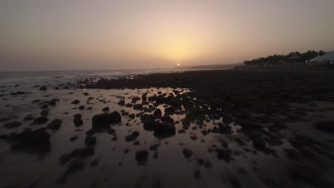 Aerial-view-of-rocks-on-the-coast-and-ocean-at-sunset