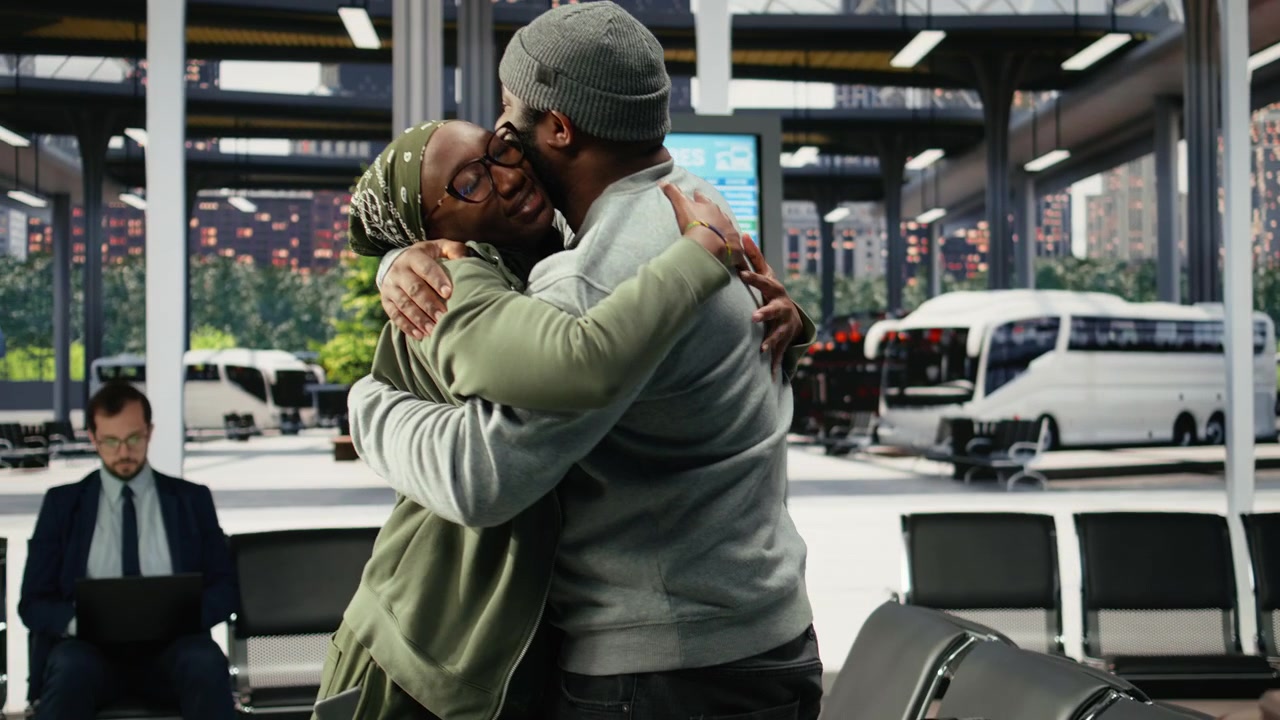 Couple embracing in bus terminal before departure during emotional goodbye