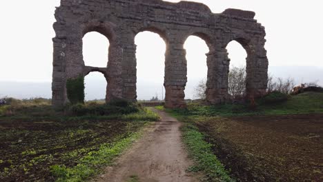 Detail-of-an-aqueduct-from-ancient-Rome-in-parco-degli-acquedotti-in-the-outskirts-of-the-capital-of-Italy,-Dolly-movement-forward-way