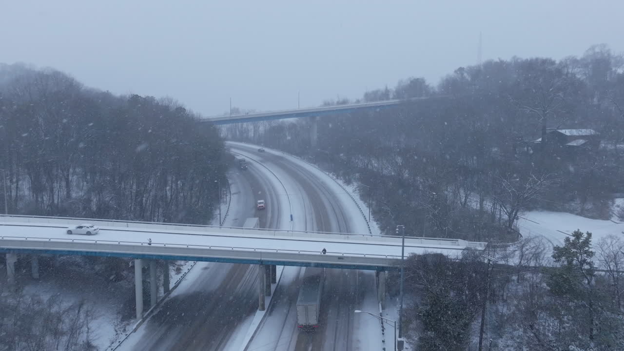 Aerial footage following a semi-truck on the highway heading towards chattanooga, tn in the snow.