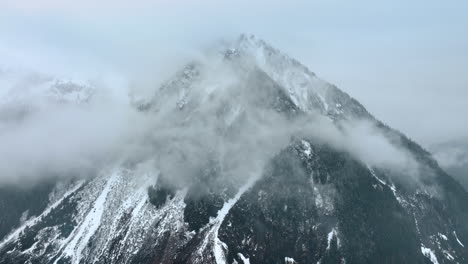 spectacular view of the huge mount coated with fog. some snow lies on the mountain in mount rainer national park, washington state, the usa.