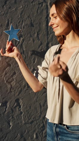 woman holding stars in sunlight