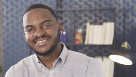 Young-black-man-office-worker.-He-is-looking-at-the-camera-and-laughing.