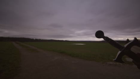 Modern-Black-Swordsman-Warrior-Awaiting-Battle-Opponent-in-Open-Field-Under-Red-Sky,-Europe,-4K-|-Muscular,-Intimidating,-Shadow,-Figure,-Blurry,-Dark-Clothes,-Powerful,-Hand-Close-Up,-Stab