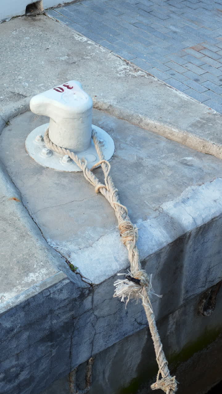 Dockside bollard with mooring rope